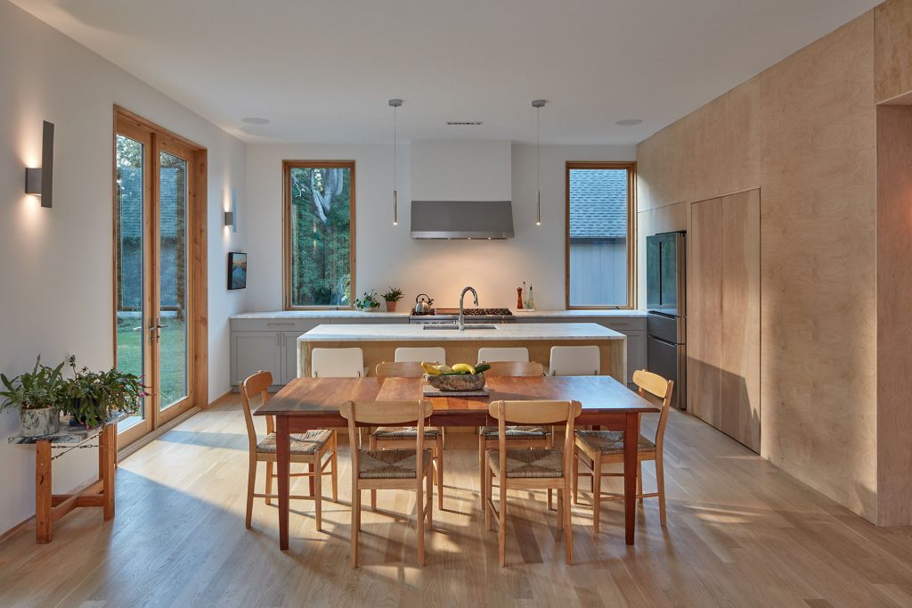 Natural light filters into the home’s open kitchen,  whose spare minimalism and symmetrical design  elements create an oasis of calm.