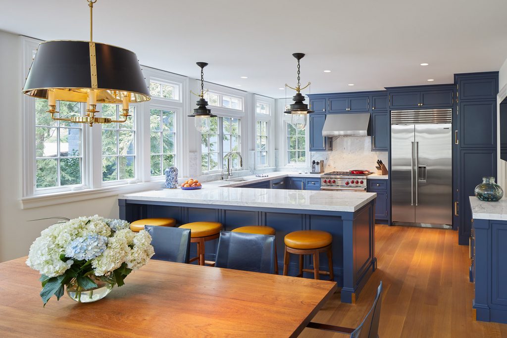 The spacious kitchen with built-in appliances and deep blue walls is a subtle homage to the Naval Academy’s signature colors.