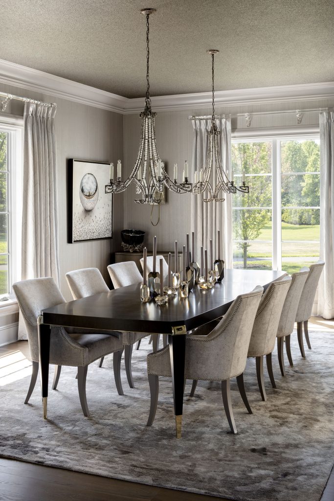 Double chandeliers and formal drapery add a stately air to the dining room.