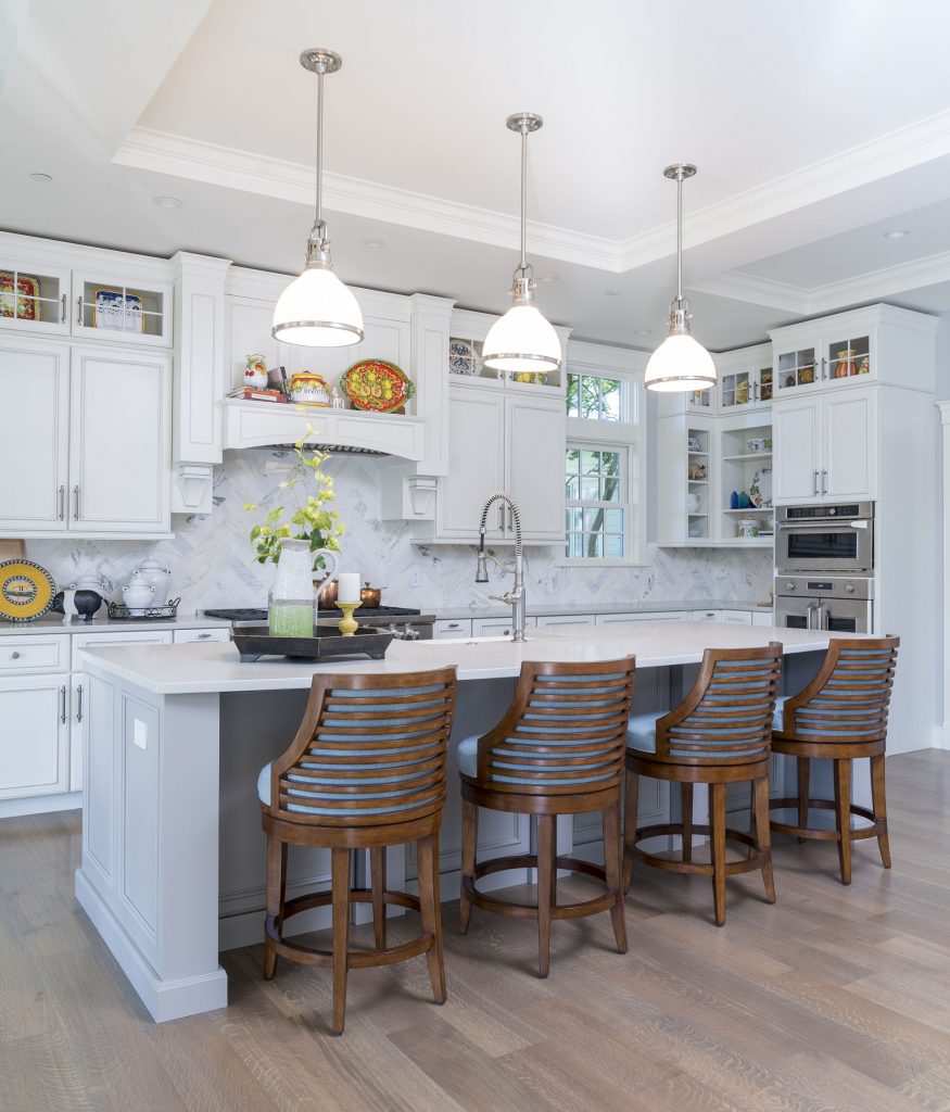 Just off the dining room, the kitchen is “big with plenty of storage.” A Carrera marble backsplash in a herringbone pattern accentuates the chef’s stove. The room’s generous proportions, the giant island, and large-scale cabinets communicate abbondanza, Italian for abundance.