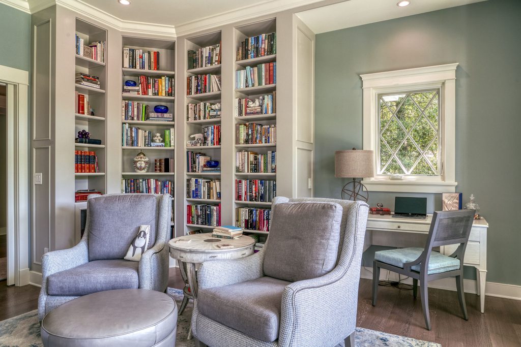 A cozy library with fireplace and floor-to-ceiling bookshelves is the retired couple’s favorite room in the house.