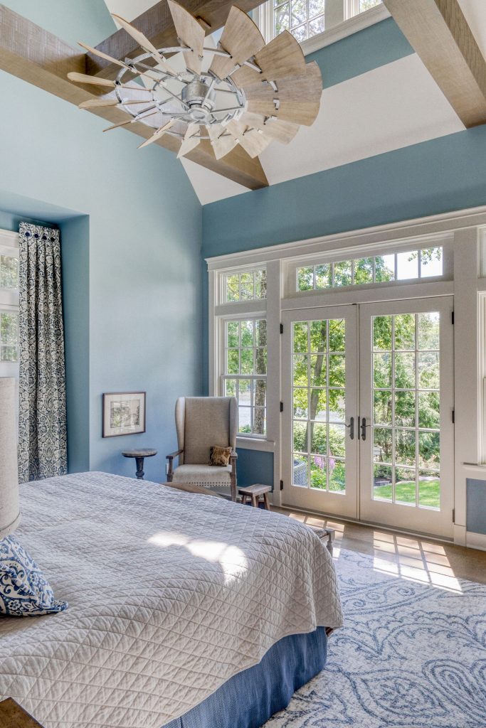 Ceiling beams and a whimsical fan add charm to this first-floor master suite. 