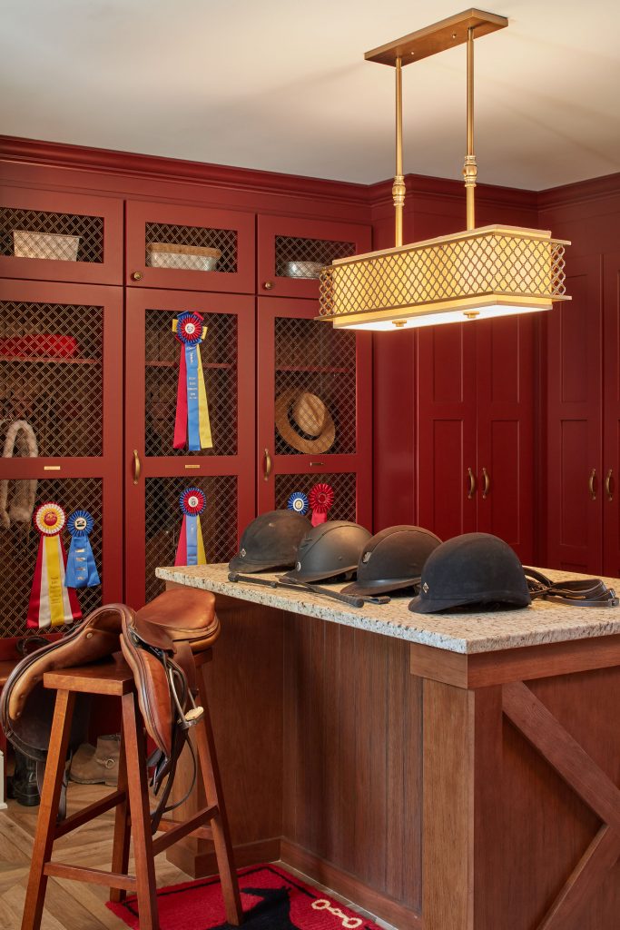 The homeowner grew up showing horses and rides with her daughter. Custom cabinets in the bar area are made from antique barn wood hand-selected by the homeowner. 