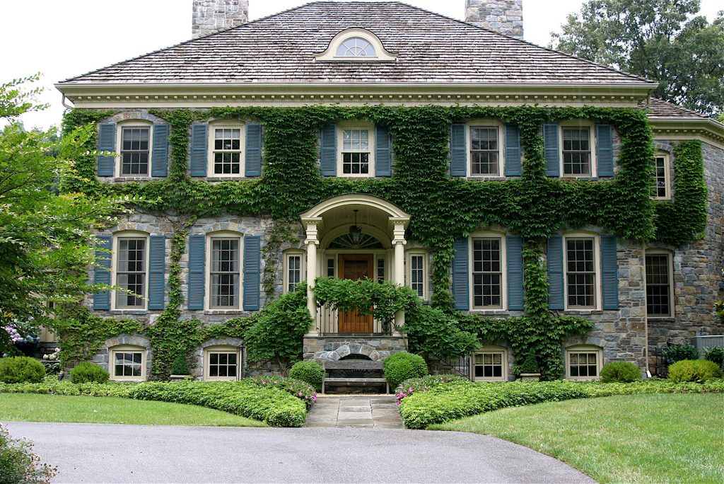 The plantings around this stone manor enhance its architectural style.