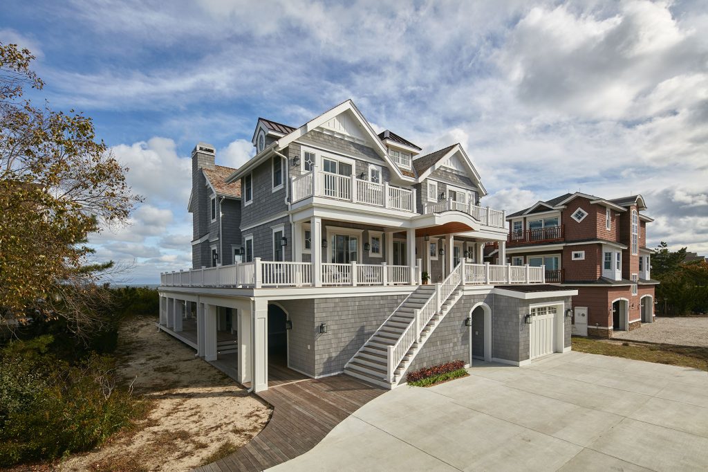 The dimensions of this huge Nantucket-inspired beachfront home are downplayed in spaces designed to feel personal and comfortable.