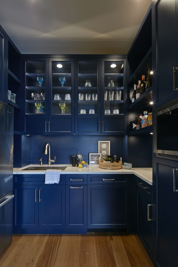 A butler's pantry is equipped with a full  bar for entertaining.