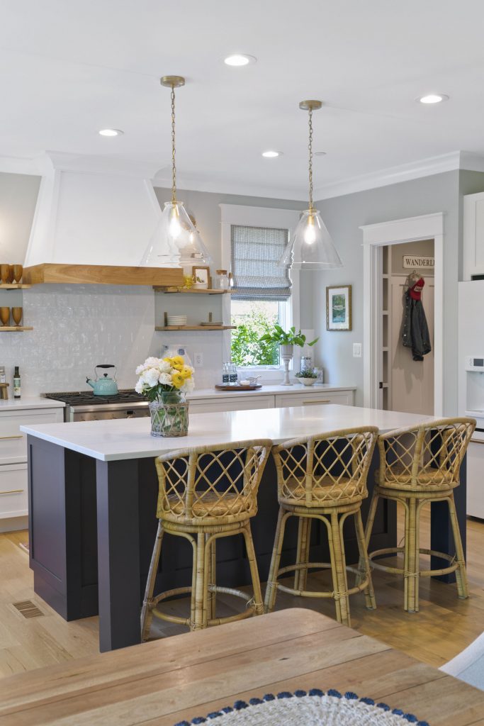 Elements like the kitchen island help create designated areas within the open living space.