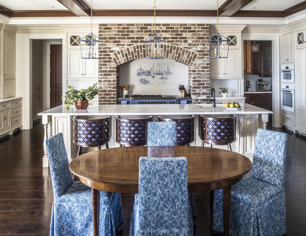 The Savannah brick surrounds the range, which matches the brick in the living room. The backsplash is created with Delft tiles from Amsterdam, which the homeowner discovered after much sleuthing. 