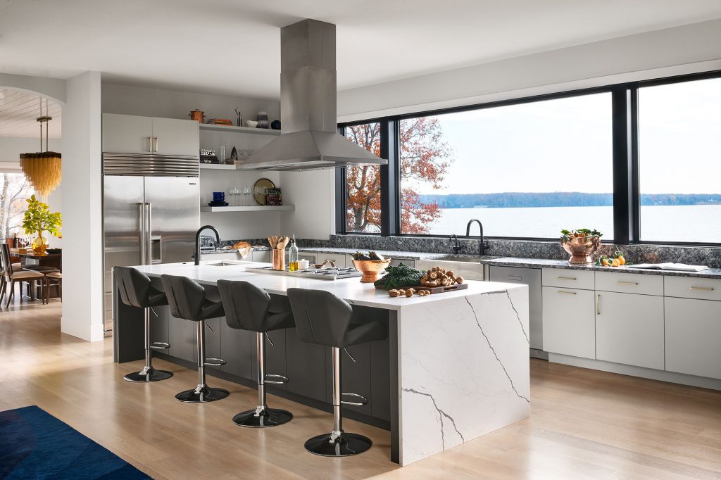 A neutral design scheme of mostly grey and white in the kitchen does not detract from river views.