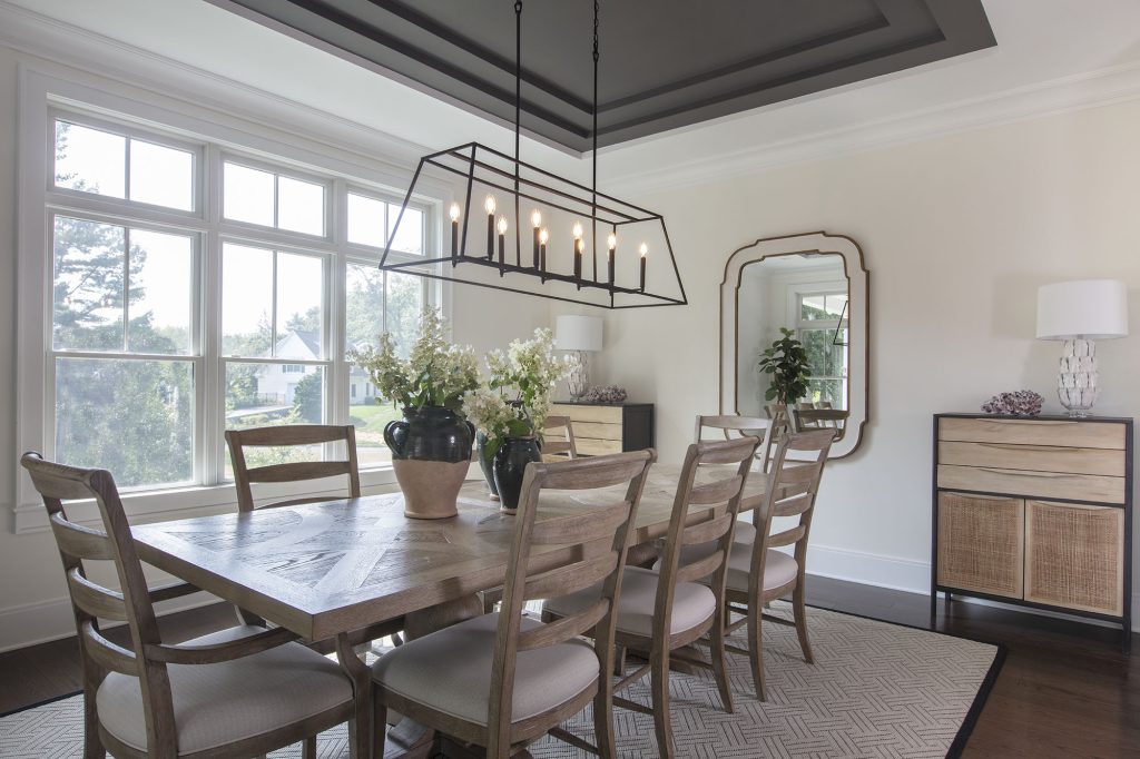 The dining room has a tray ceiling to create aesthetic variation and is painted Kendall Charcoal by Benjamin Moore.