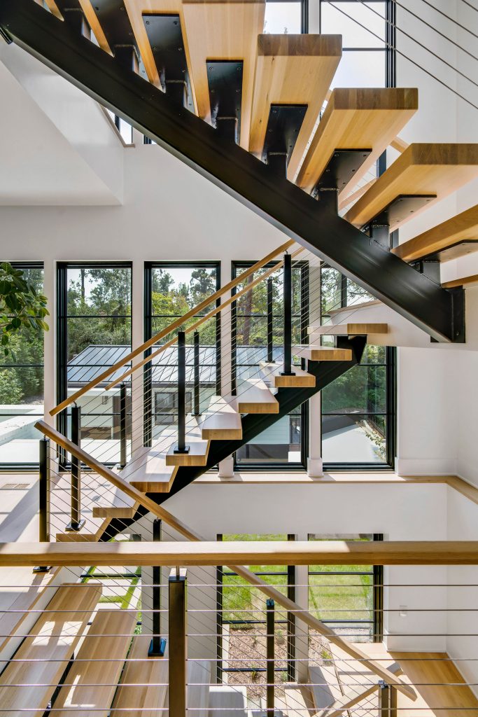 Floating stairs connect the home’s four floors of living space.