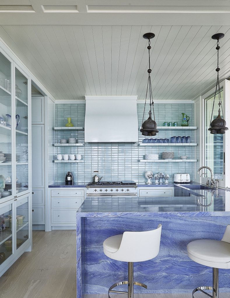 The kitchen, with many shades of pale blue, is lacquered for easy cleanup.  The light fixtures are from Syria. 