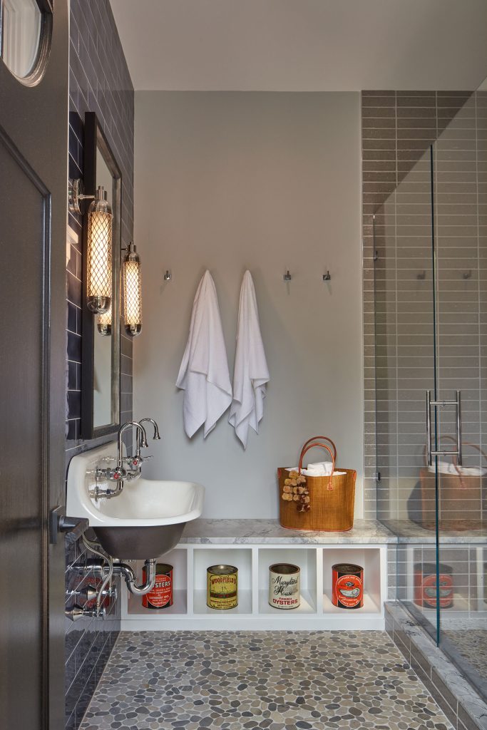 The cabaña, with its round window, is a miniature changing room; antique oyster cans pay homage to the African American watermen in the homeowner’s family history.