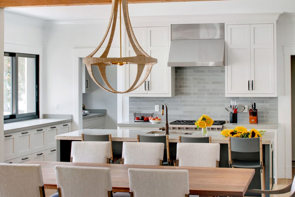 Modern light fixtures, narrow shaker-style custom cabinetry, and light, bright colors and finishes ensure a contemporary ambiance.
