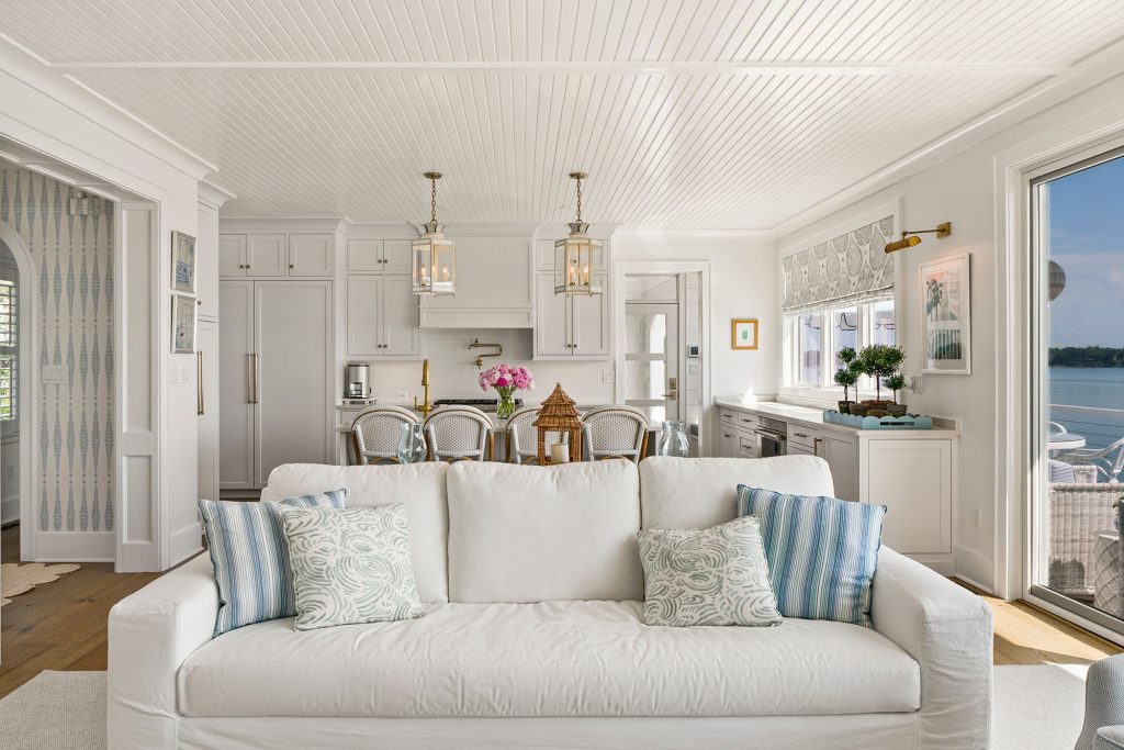Coastal shades of blue in the throw pillows and window treatments lend interest to the space.