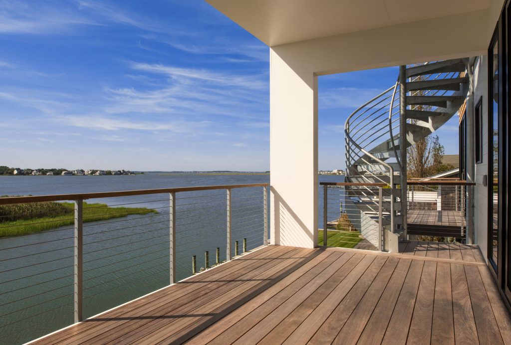 With its white elevated porch steps, airy spiral staircase and multiple decks, this home takes advantage of views, sun patterns and prevailing winds off the Bay.