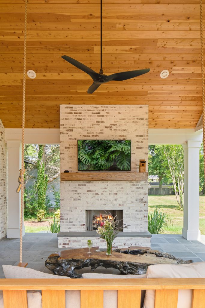 A custom fireplace and covered roof with knotty pine built by Greg Younger’s team add elegance and charm to the property.