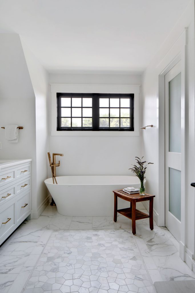 The marble floor in the primary bath was designed, piece-by-piece, by the homeowner and interior designer in the primary bedroom during construction.