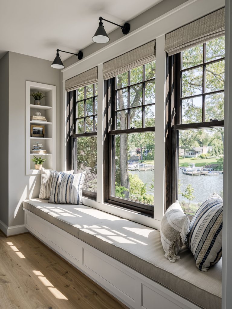 Dark bronze windows contrast nicely with the light neutral colors of the walls and textiles.