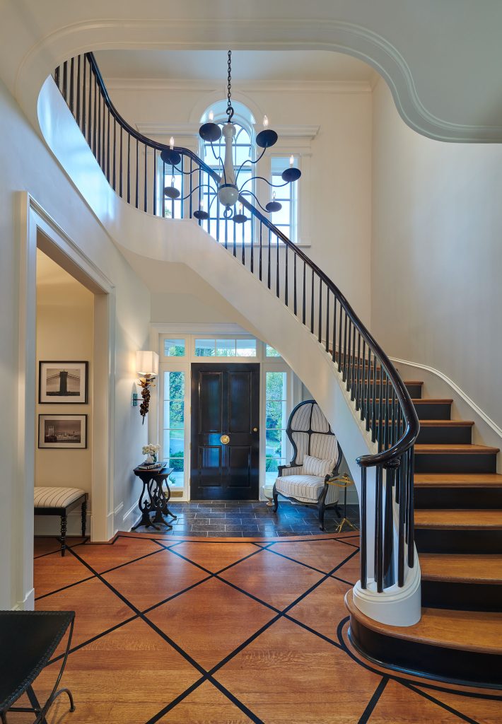 An intimate entryway  opens up into a dramatic hall.